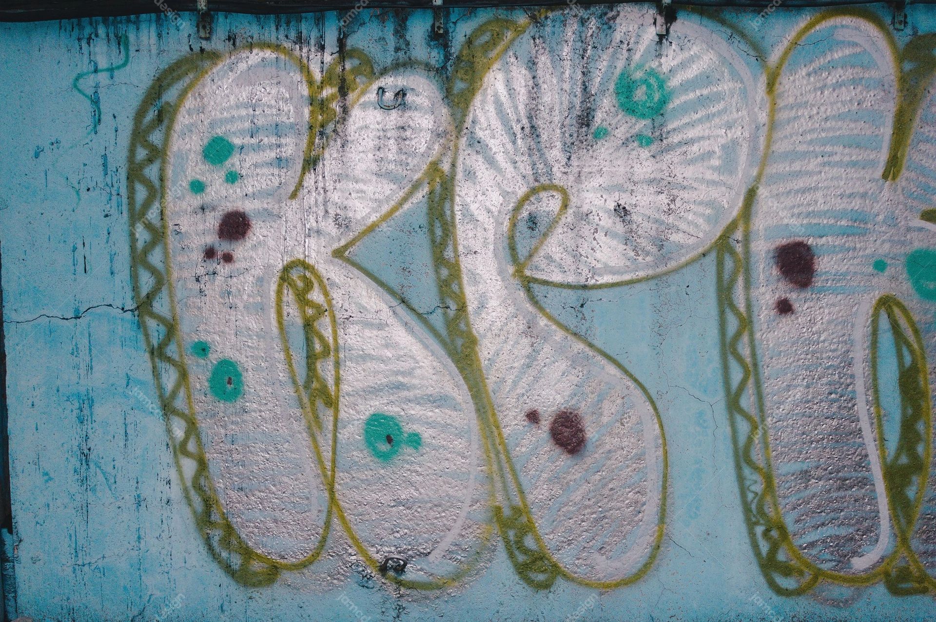 Oversized Graffiti Lettering Wall Texture. This JPG texture shows oversized pale blue graffiti lettering with muted pink fills and olive green outlines across