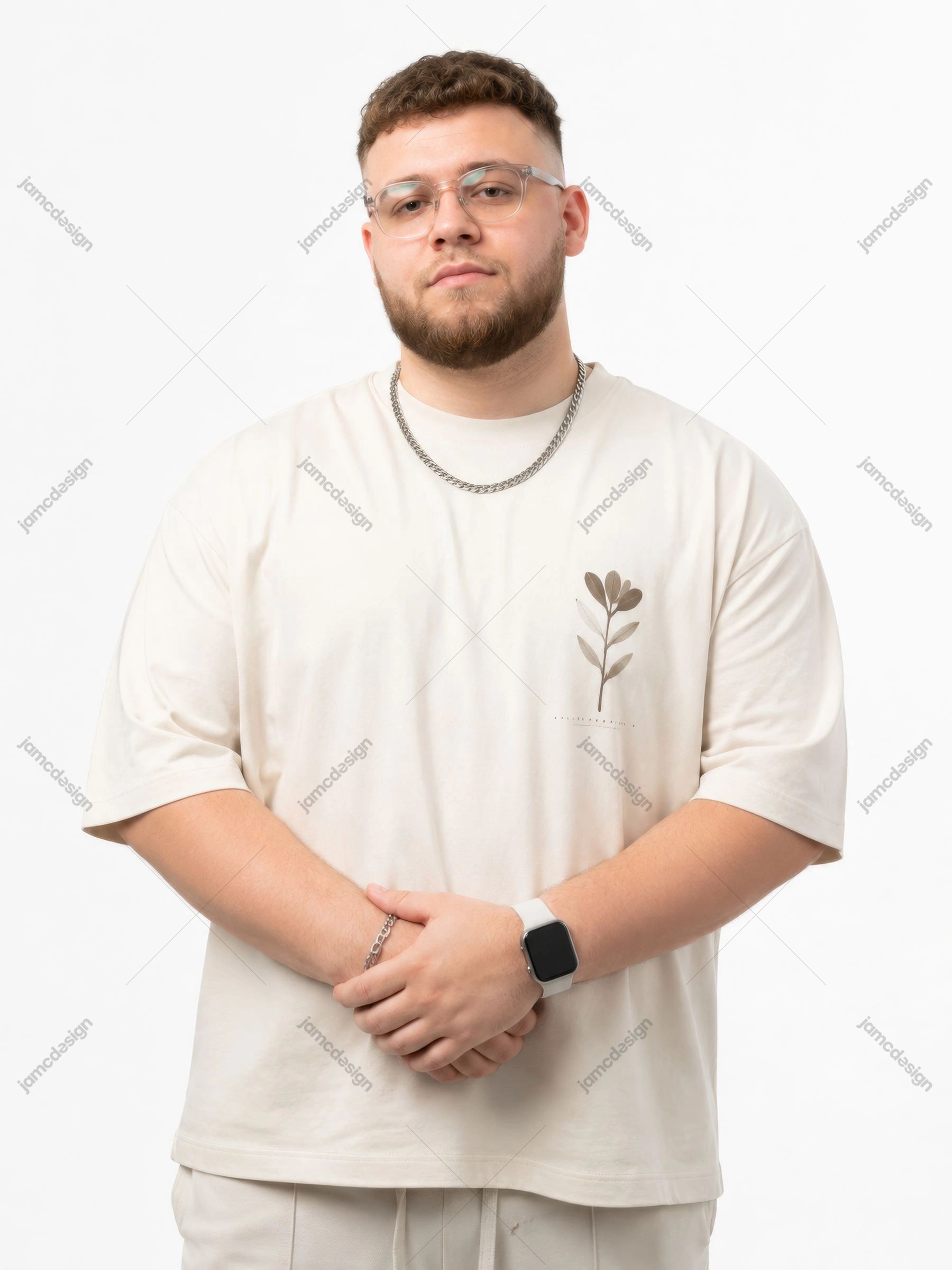 Male Artist Cream Outfit Studio Glasses Chain Portrait JPG. JPG studio of a bearded man wearing a cream T shirt, glasses and a chain