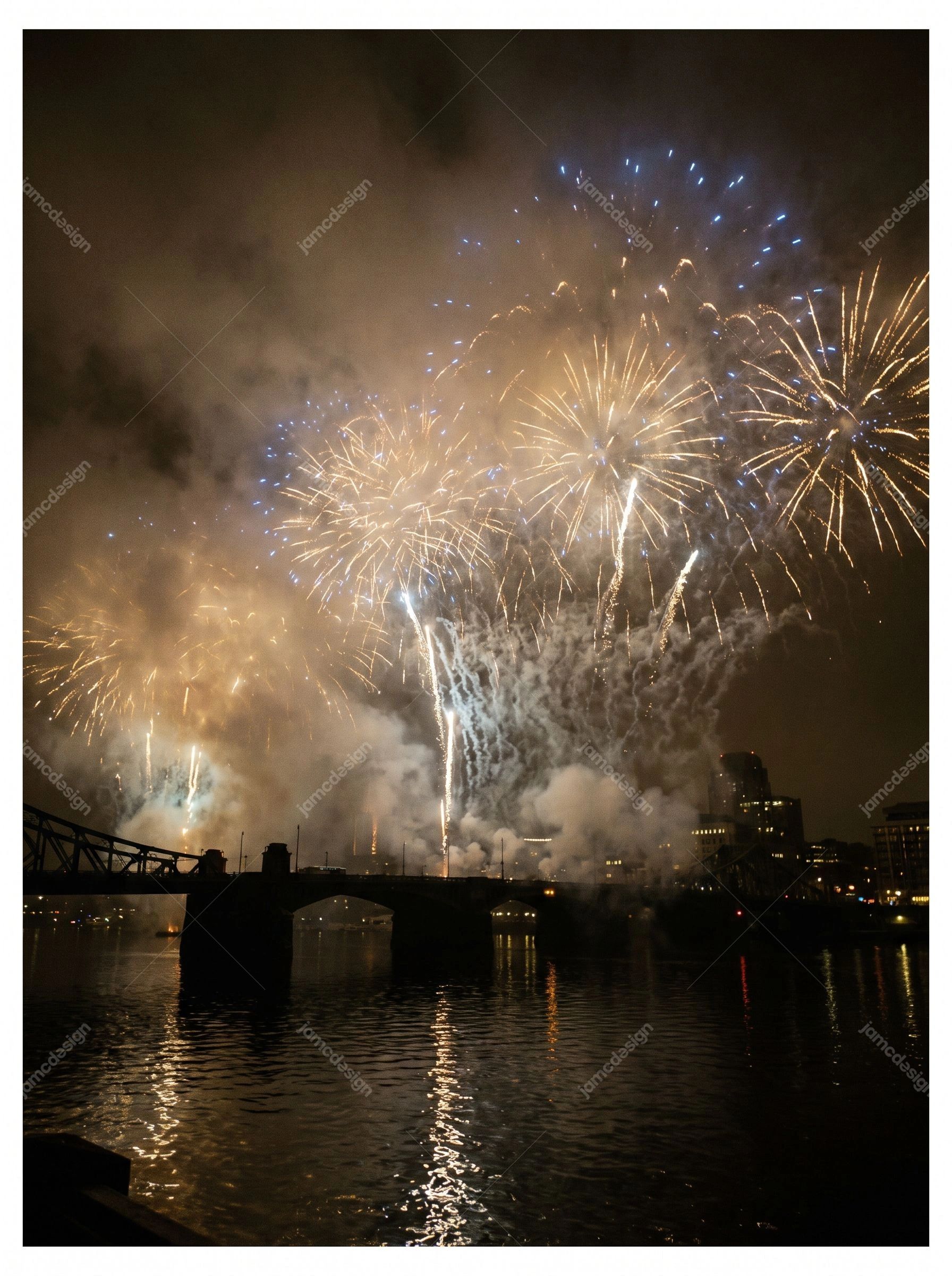 New Year Fireworks Over Illuminated City Skyline. This JPG photo captures golden and blue fireworks above an illuminated city skyline