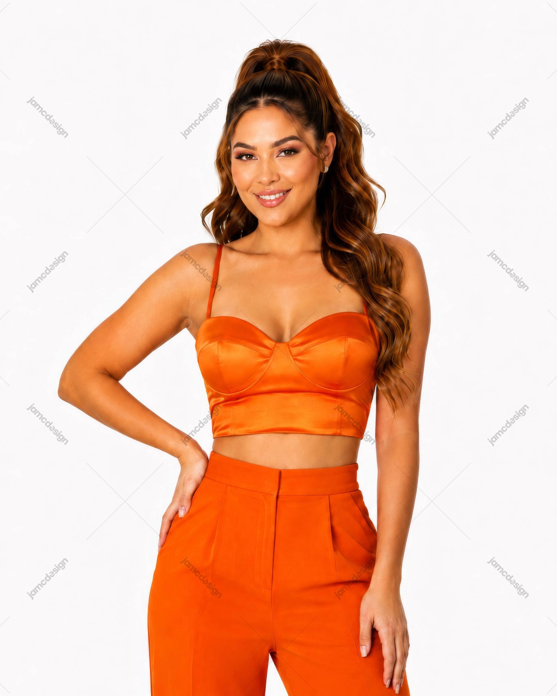 Woman In Orange Satin Crop Top And Pants Photo. Studio fashion photo of a smiling model in a bright orange satin crop top with sweetheart neckline