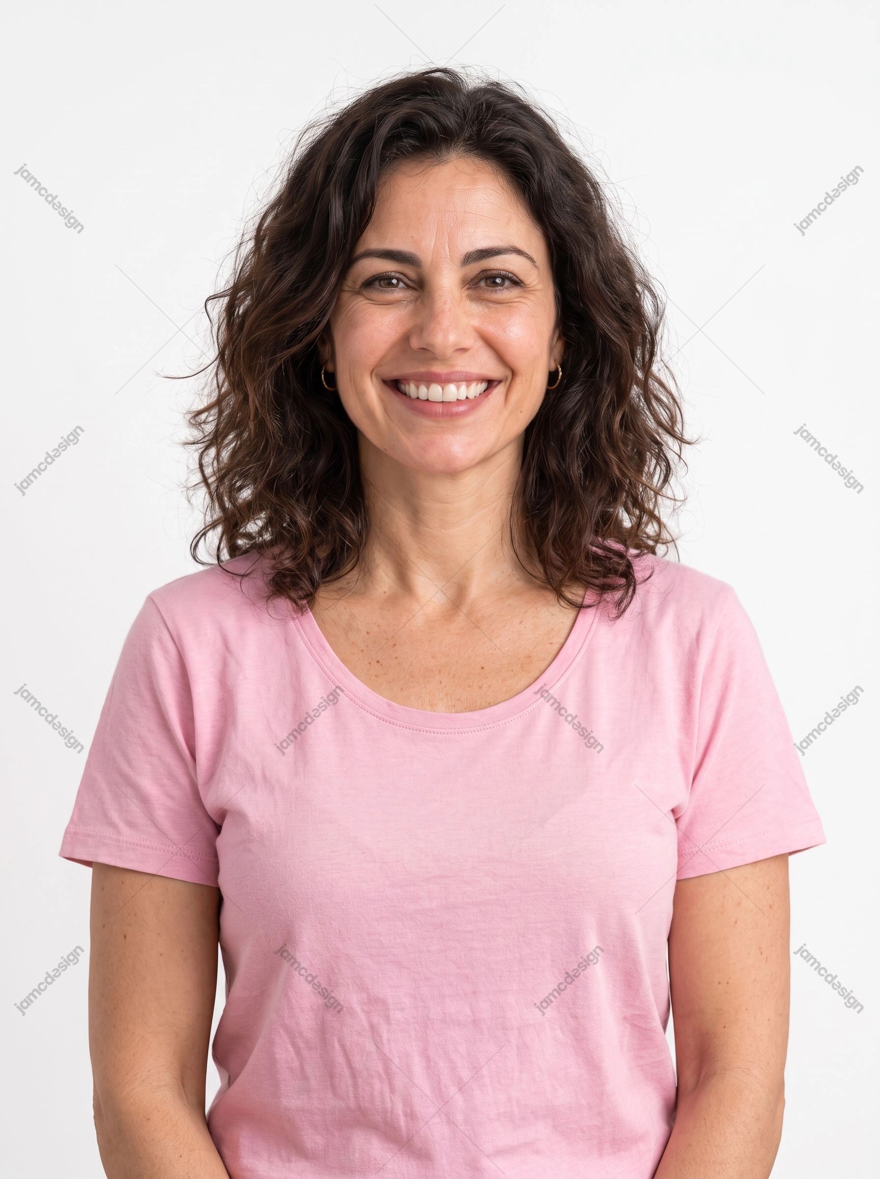 Smiling Brunette Woman Studio Portrait. This JPG studio photo shows a smiling brunette woman in a pink shirt against a plain light background
