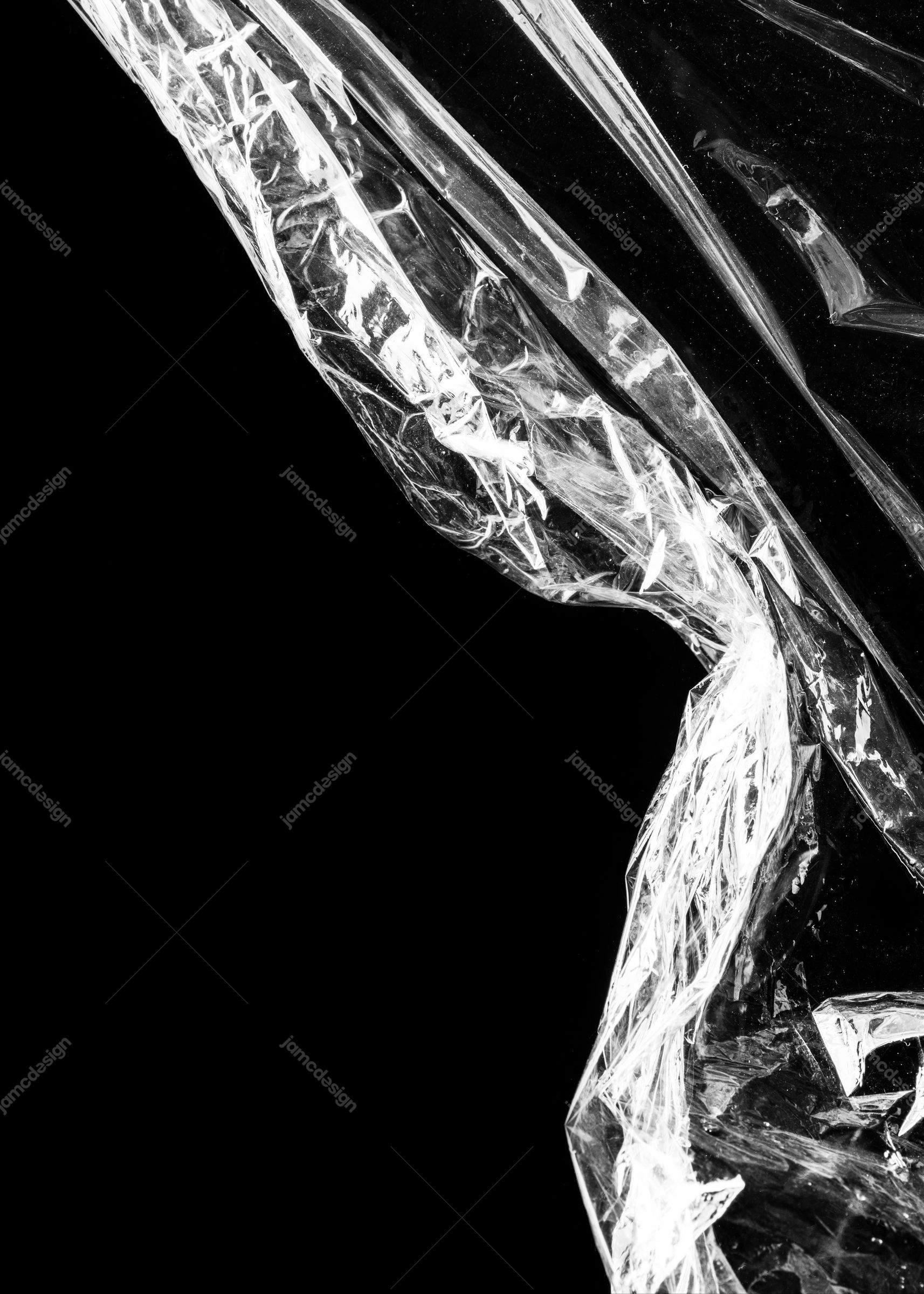 Reflective Crinkled Plastic Texture With Highlights. This JPG texture captures clear plastic folds and sharp white highlights against a black background