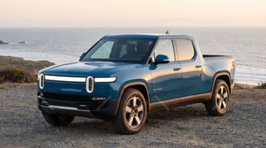 Blue Rivian R1T Pickup At Coastal Sunset