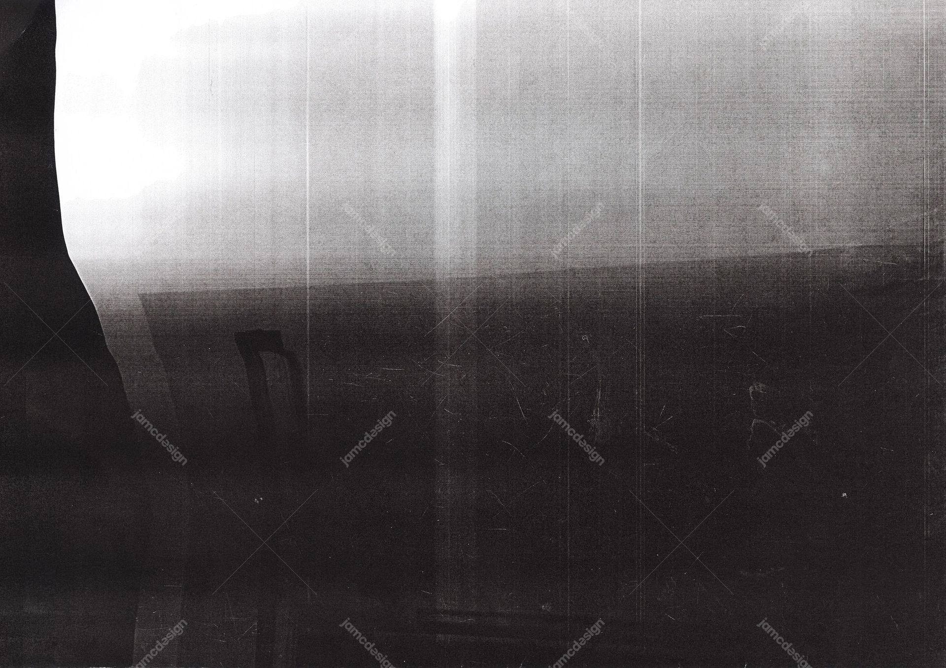 Silver Light Leak Texture Background. This JPG texture shows a silver light leak fading into a dark, scratched surface