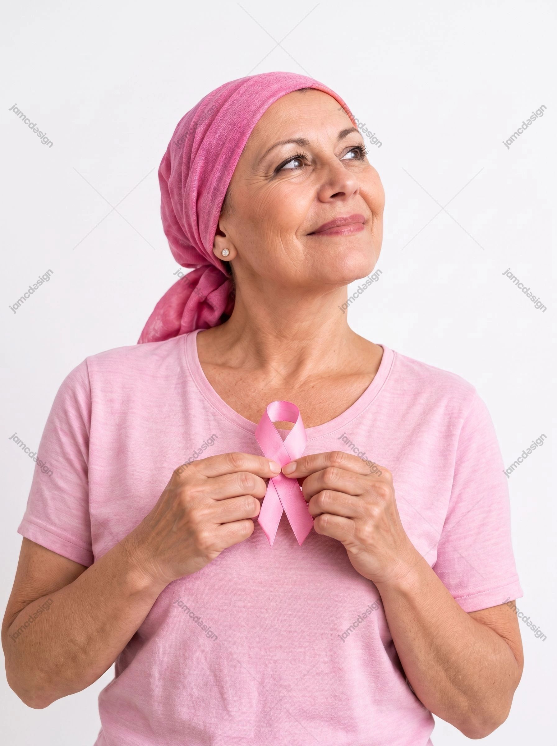 Breast Cancer Awareness Portrait With Pink Ribbon. This realistic JPG photo shows a woman in a pink headscarf holding a pink awareness ribbon against a plain