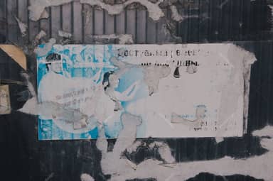 Urban Wall Texture With Faded Blue Torn Posters