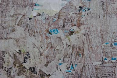 Grunge Texture Of Torn Layered Posters On A Wall