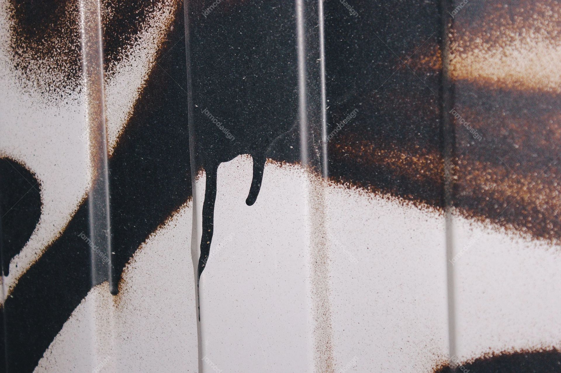 Dripping Spray Paint On A Pale Surface Texture. This monochrome JPG texture shows black spray paint feathering across a pale surface