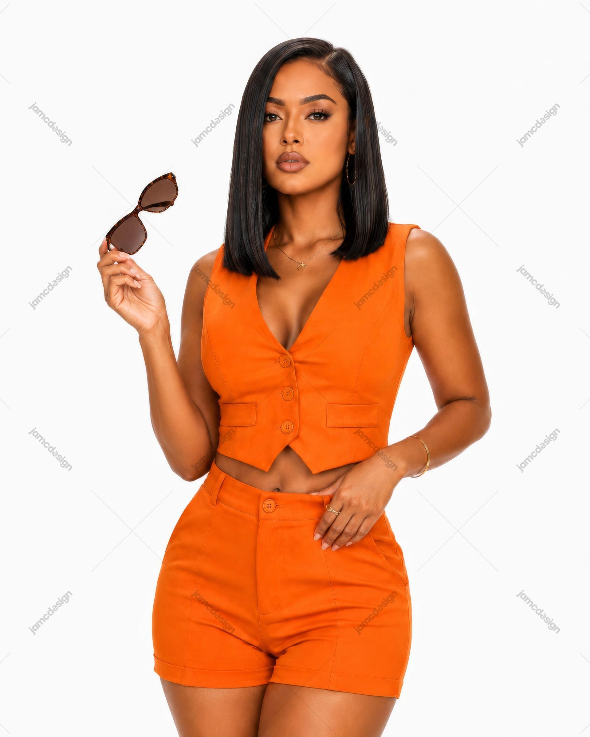 Woman In Orange Vest And Shorts Holding Sunglasses Photo. Studio photo of a woman with a sleek dark bob wearing a matching orange vest and shorts set