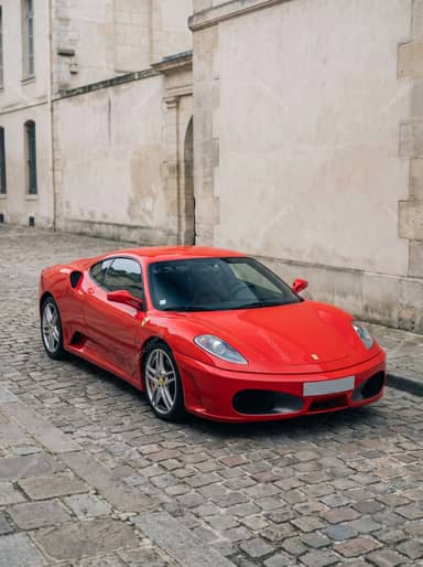 Red Ferrari F430 In A Cobblestone Courtyard