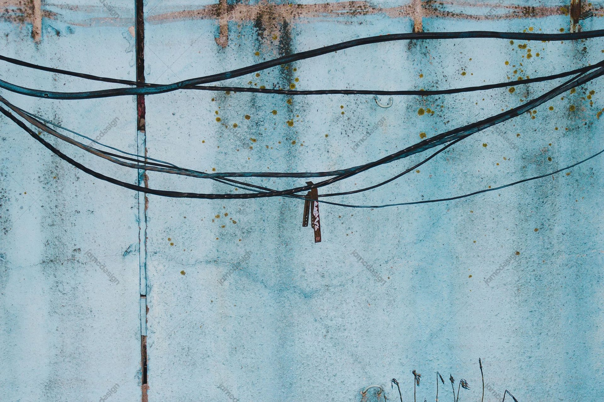 Weathered Aqua Wall Texture With Overhead Cables. This JPG texture shows a weathered aqua painted wall