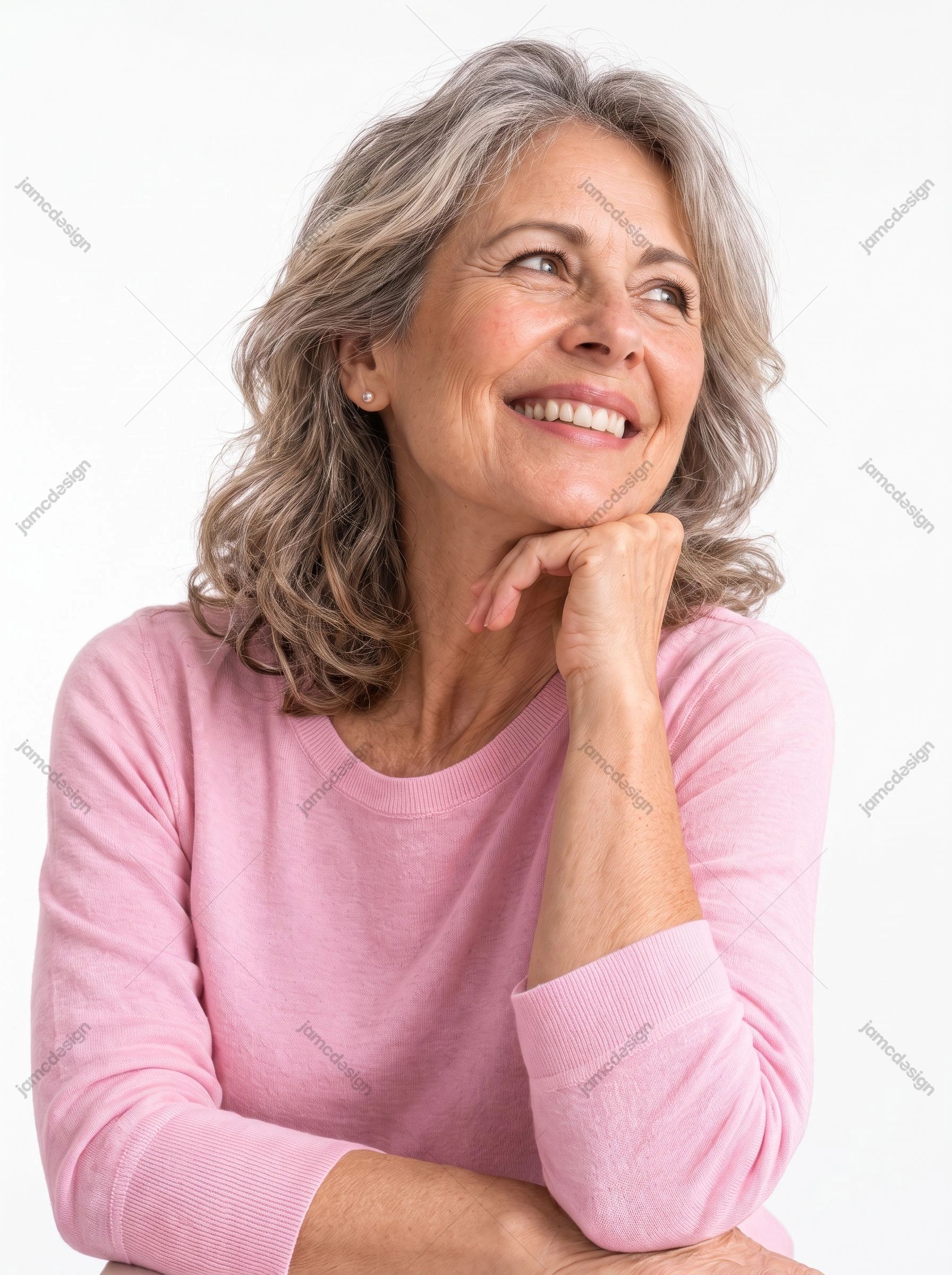 Smiling Older Woman Portrait With Gray Hair. This JPG photo features a smiling older woman with wavy gray hair resting her chin on one hand