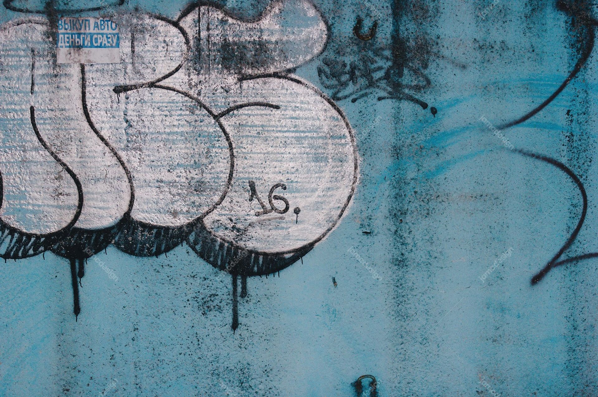 Weathered Turquoise Wall Texture With Oversized Graffiti. Download this JPG texture of an aqua blue concrete wall covered in oversized black outlined graffiti