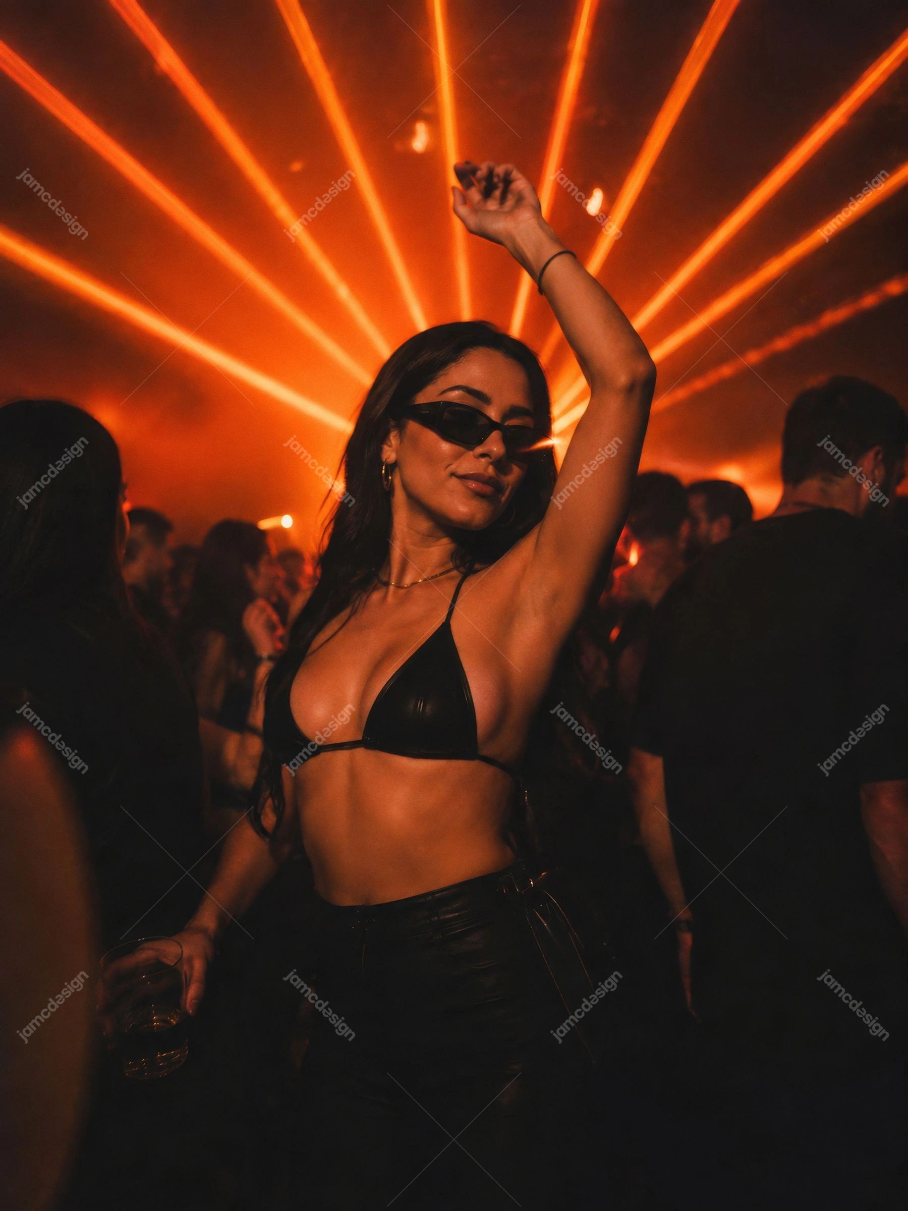 Young Woman Dancing Under Orange Club Laser Lights. JPG photo of a woman dancing in a crowded nightclub