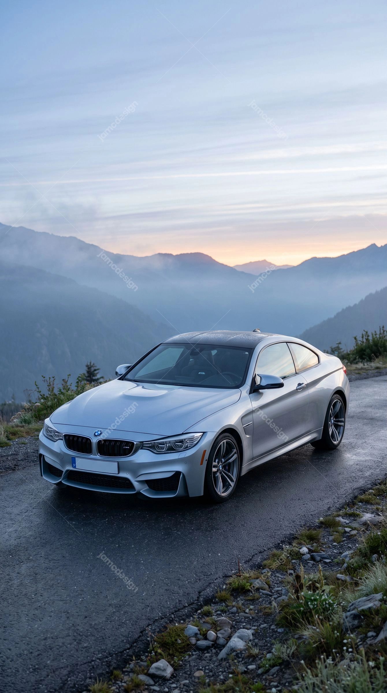 Silver BMW M4 On A Mountain Road At Dawn. This JPG photo shows a silver sports car parked on a mountain road at dawn