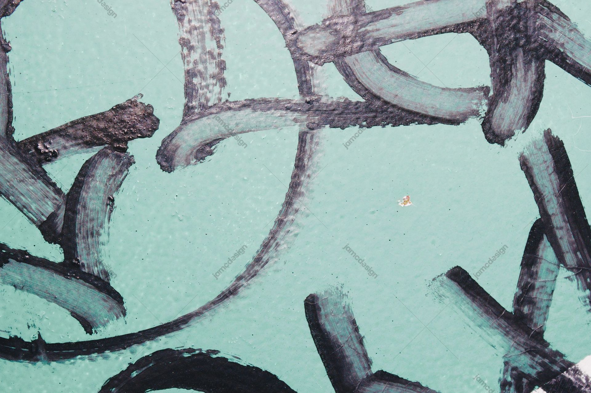 Turquoise Concrete Texture With Dark Graffiti. Download this JPG texture of a teal concrete wall marked by broad