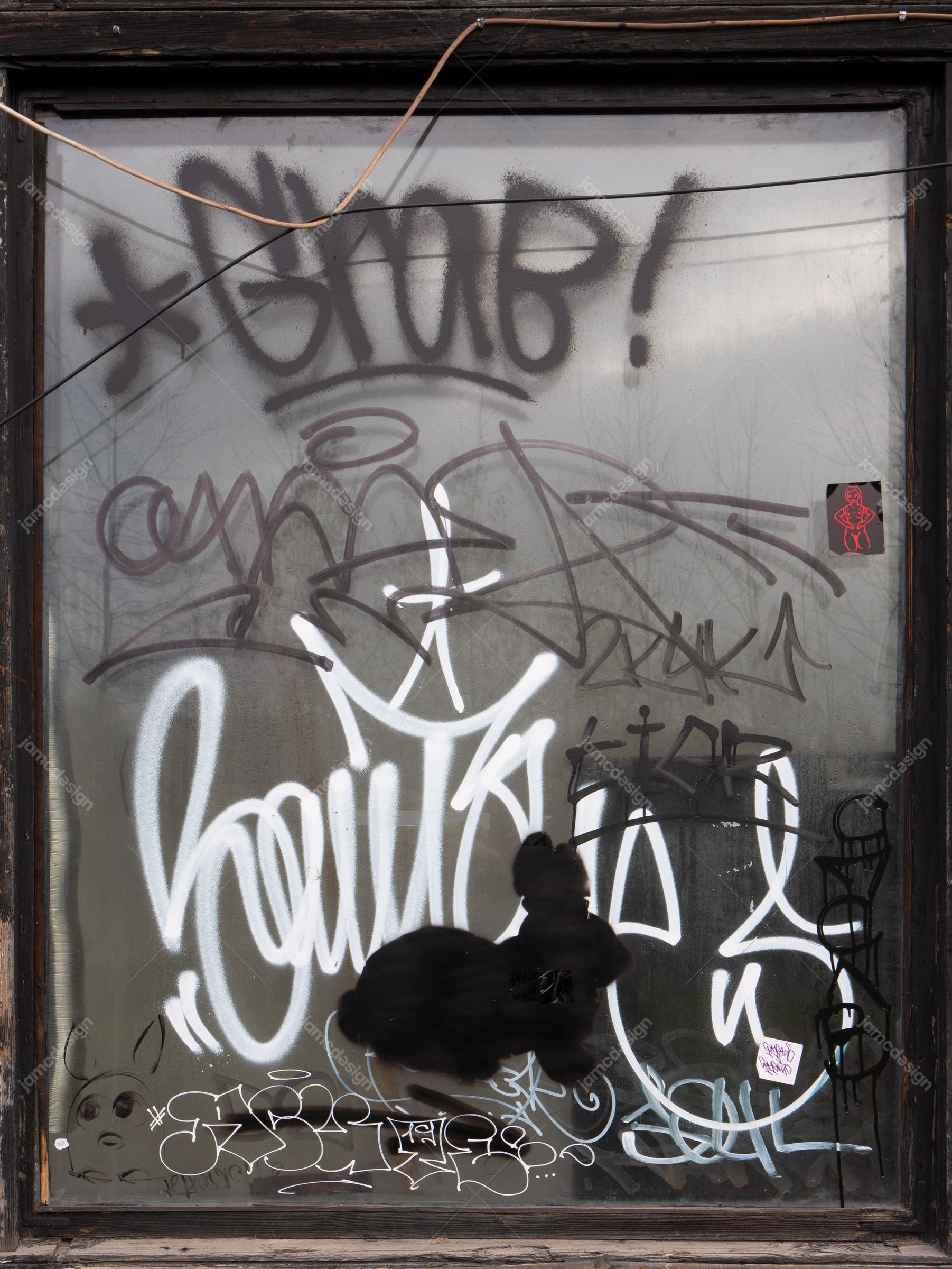 Graffiti On Glass Pane Texture PNG. This PNG texture shows layered graffiti marks across a weathered concrete wall