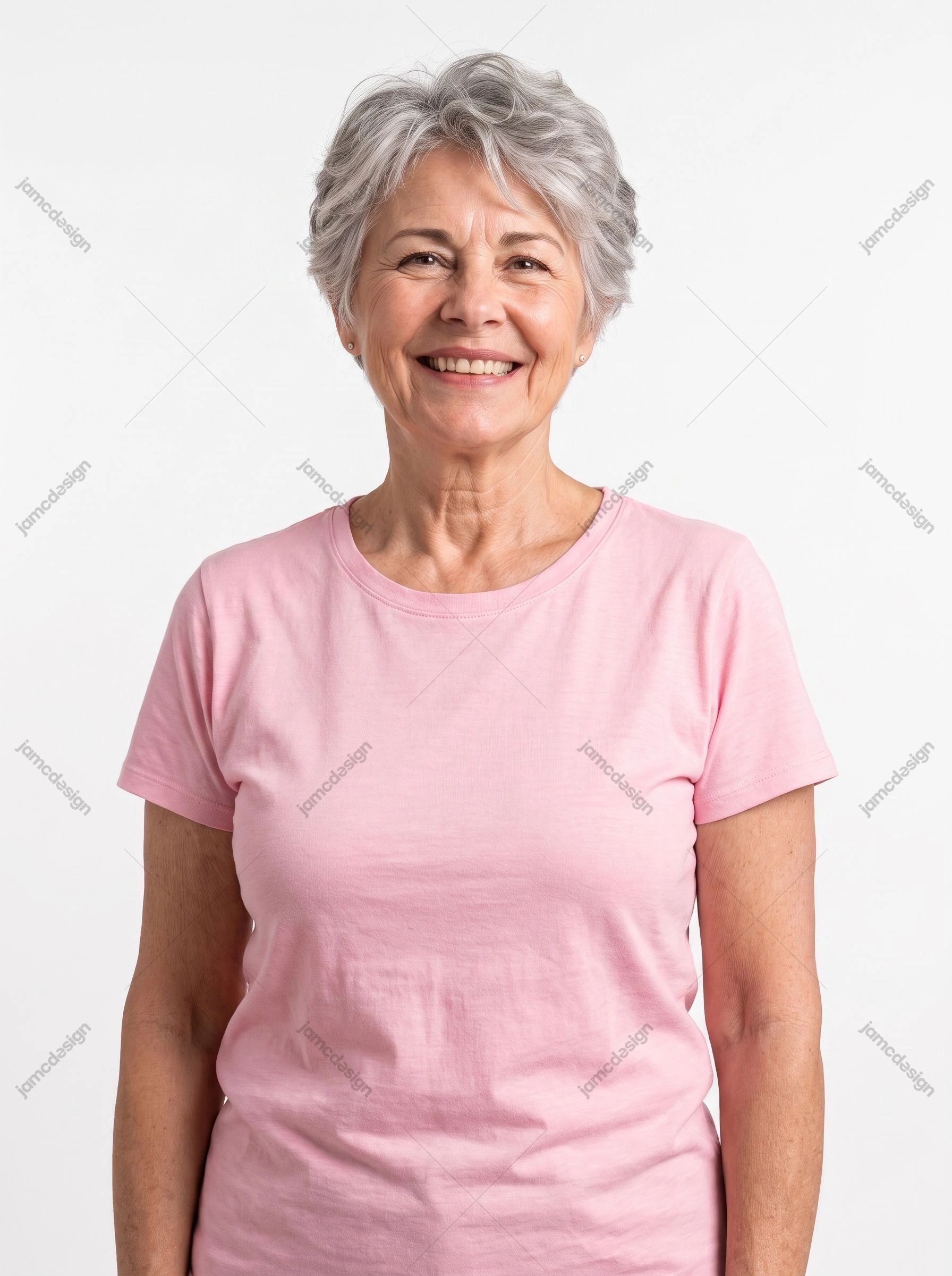 Smiling Older Woman In Pink T-Shirt. This JPG photo shows a smiling older woman with short gray hair wearing a pink T shirt against a plain white background