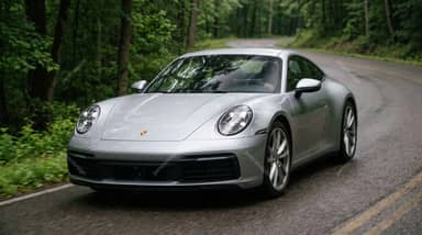 Silver Porsche 911 On Winding Forest Road