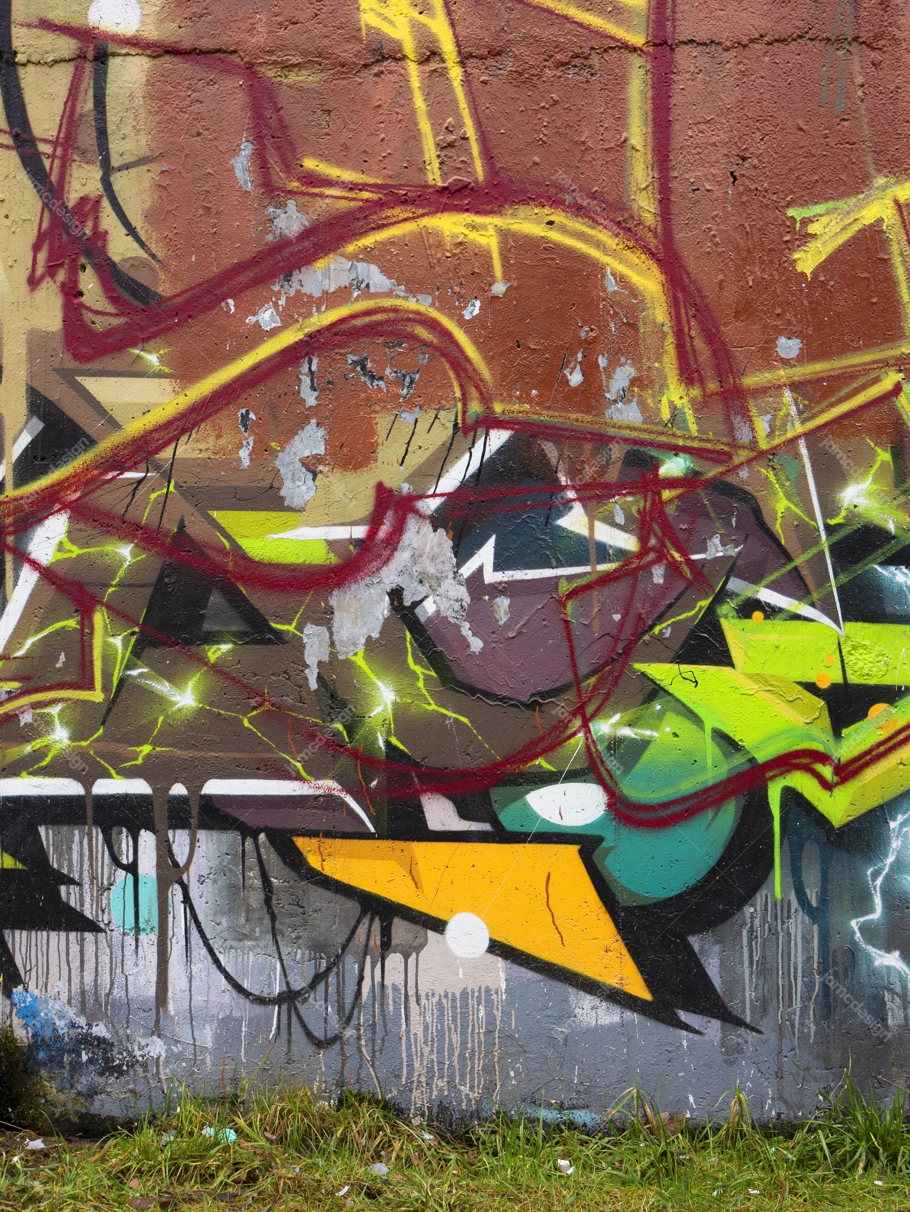 Colorful Graffiti Concrete Wall Texture PNG. This PNG texture shows colorful urban graffiti across a rough concrete wall, with layered angular shapes