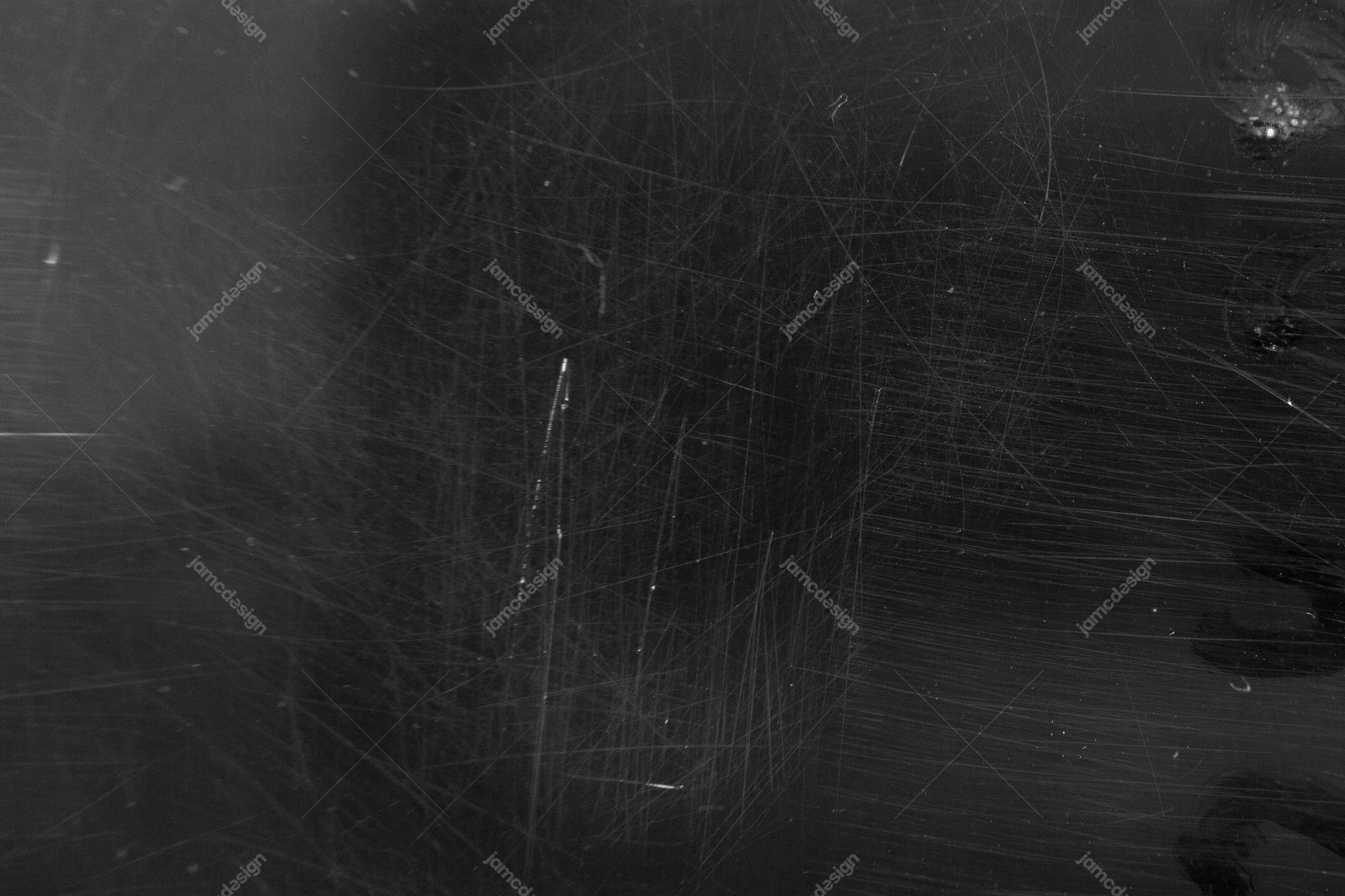 Dark Scratched Surface Texture Background. This dark monochrome JPG texture shows a densely scratched