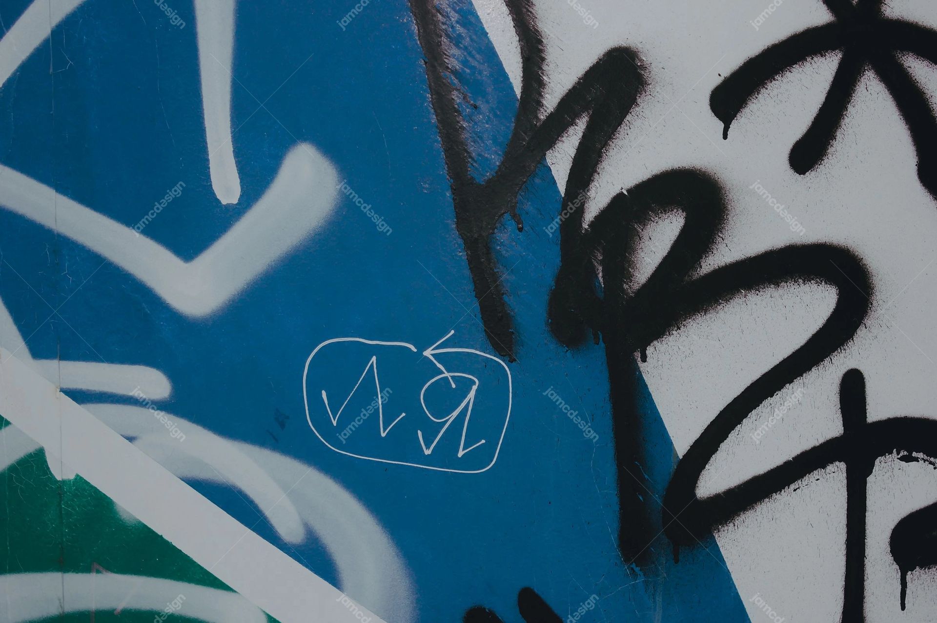 Blue Wall Texture With Black And White Graffiti. Download this JPG texture of a blue urban wall covered with bold black and white graffiti
