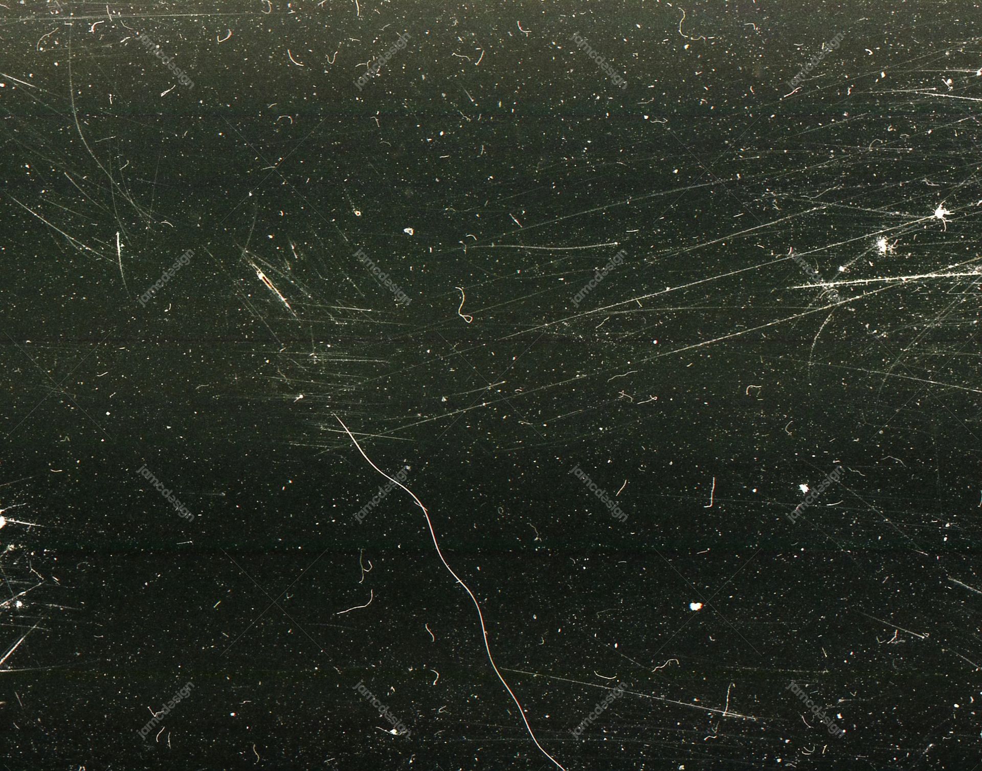 Dark Distressed Film Texture Background. This dark JPG texture shows fine dust specks, scattered pale marks and long hairline scratches across a nearly black