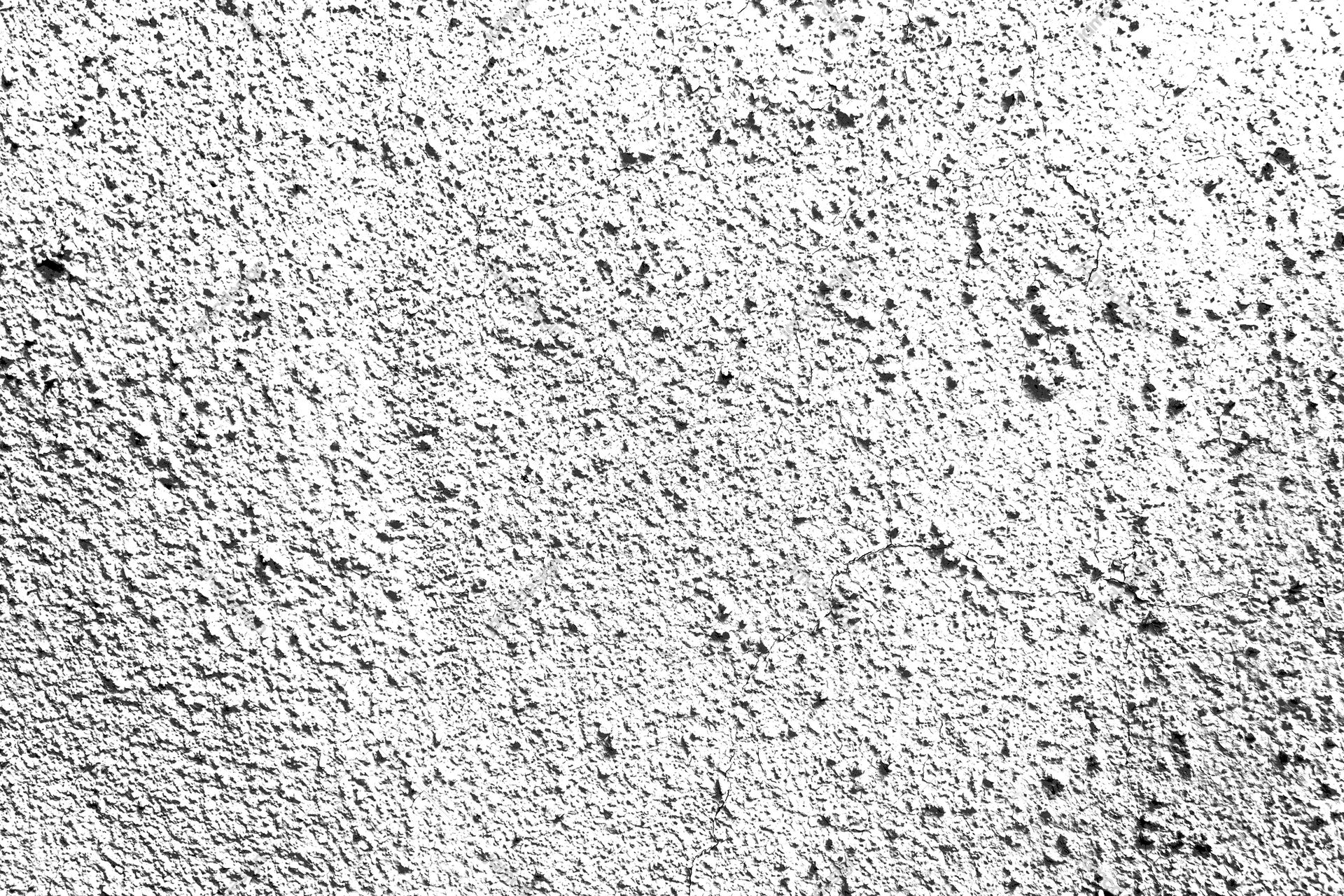 Rough Pitted Plaster Texture PNG. This PNG texture shows a rough white and gray plaster surface with dense pits and dark speckles