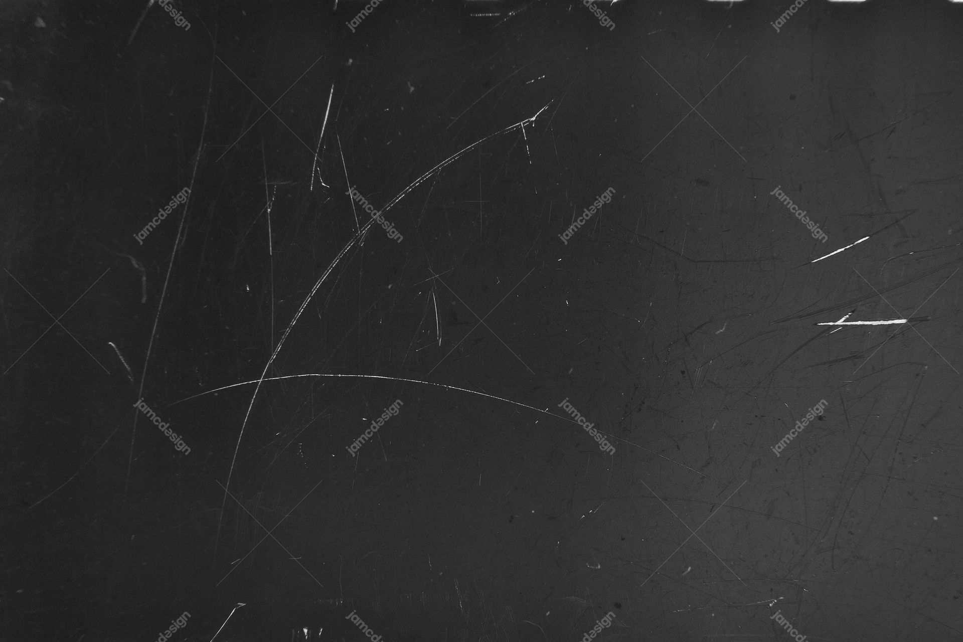 Charcoal Surface Texture With Fine Scratches. This JPG texture shows a dark charcoal surface marked by fine, irregular scratches and scattered grain