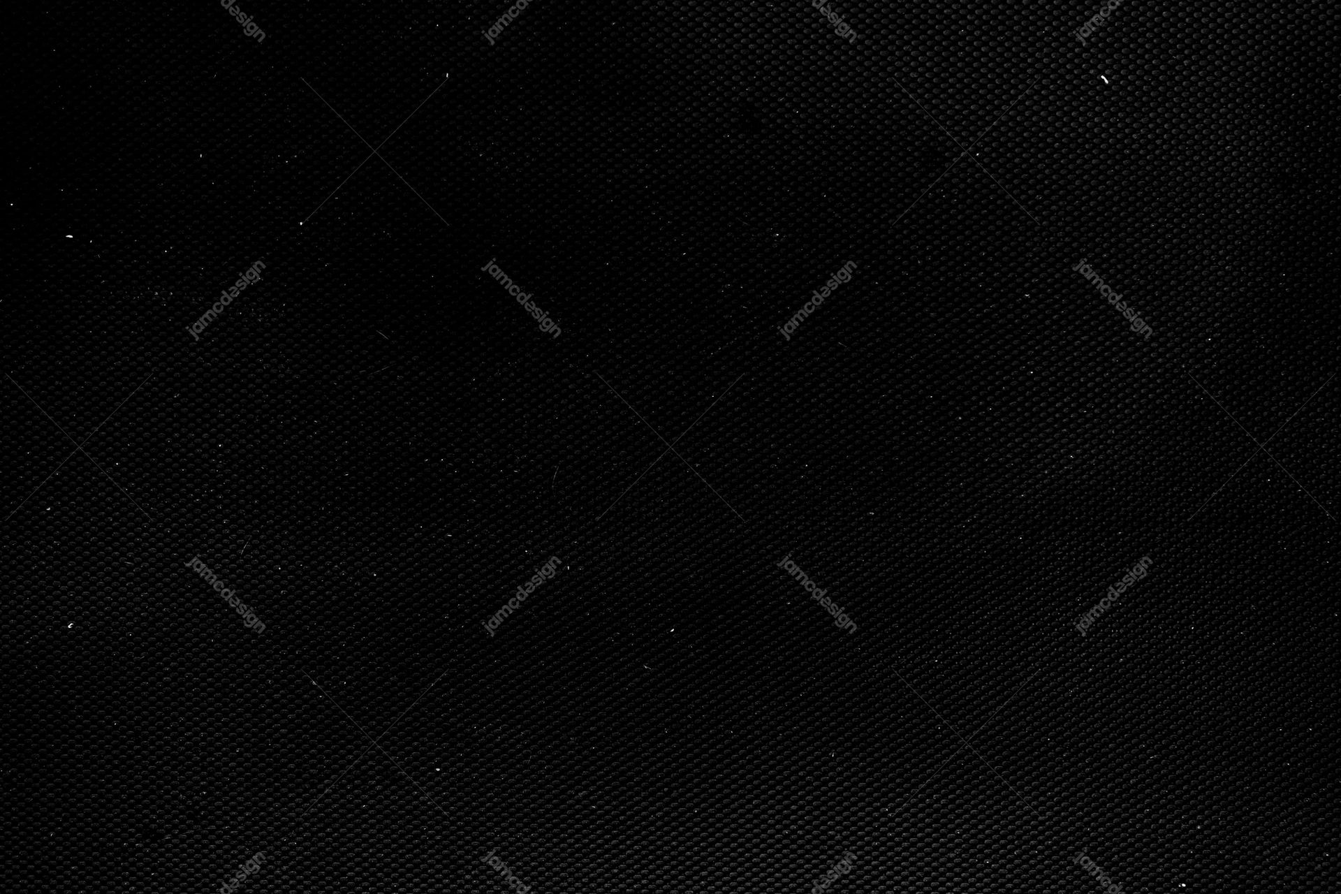 Black Woven Grain Texture PNG. This PNG texture shows a deep black surface with a fine woven grain and scattered pale specks