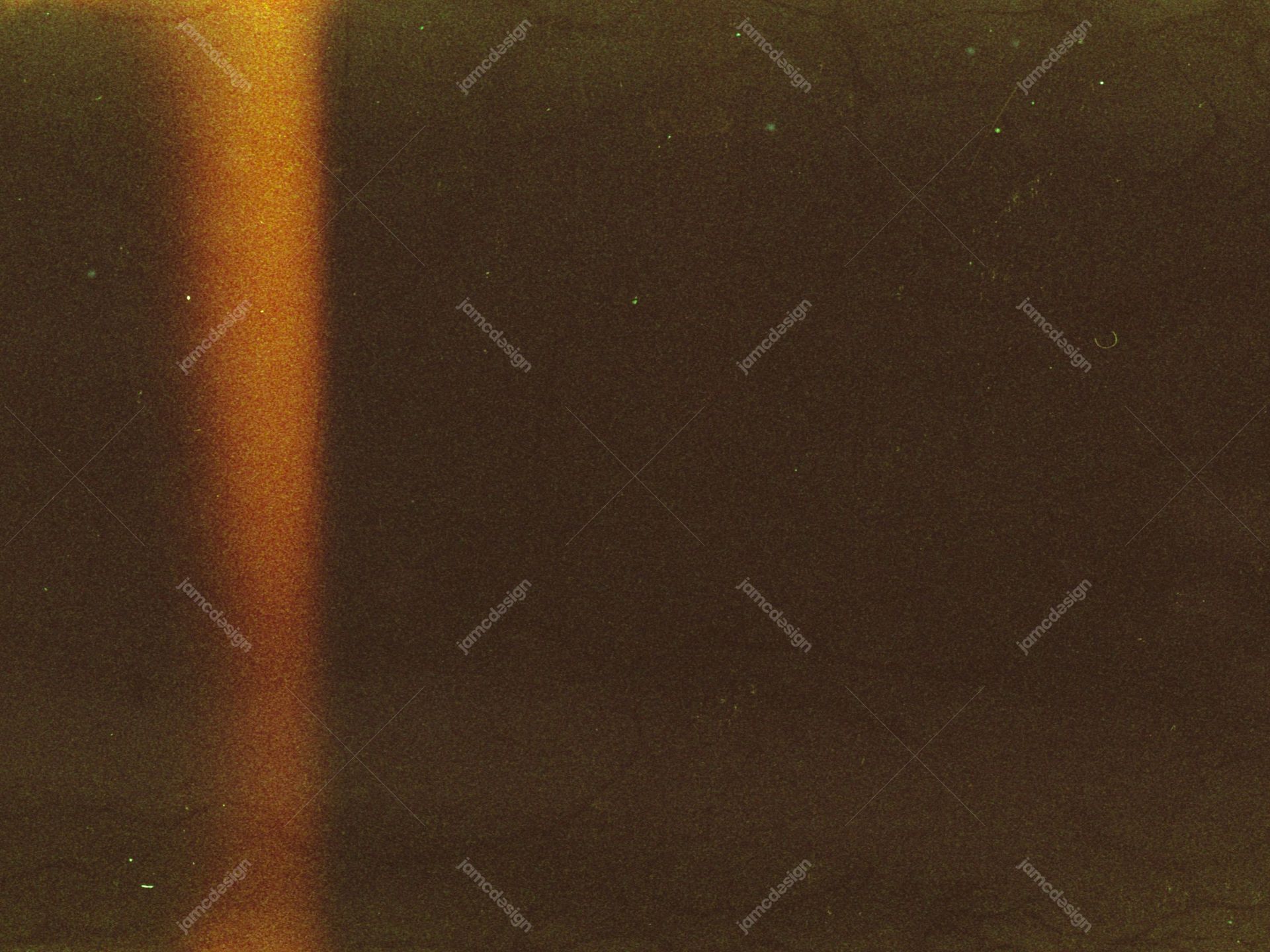 Amber Vertical Light Beam On A Grainy Texture. This JPG texture shows a warm amber lens flare against a dark, grainy field