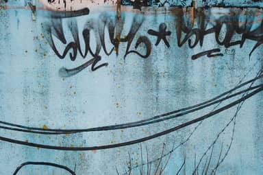 Blue Wall Texture With Graffiti And Overhead Wires