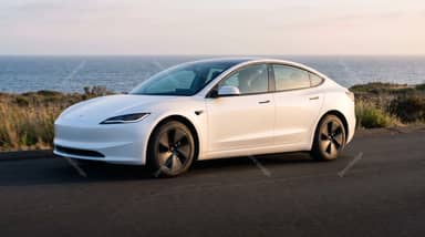 White Tesla Model 3 On A Coastal Road