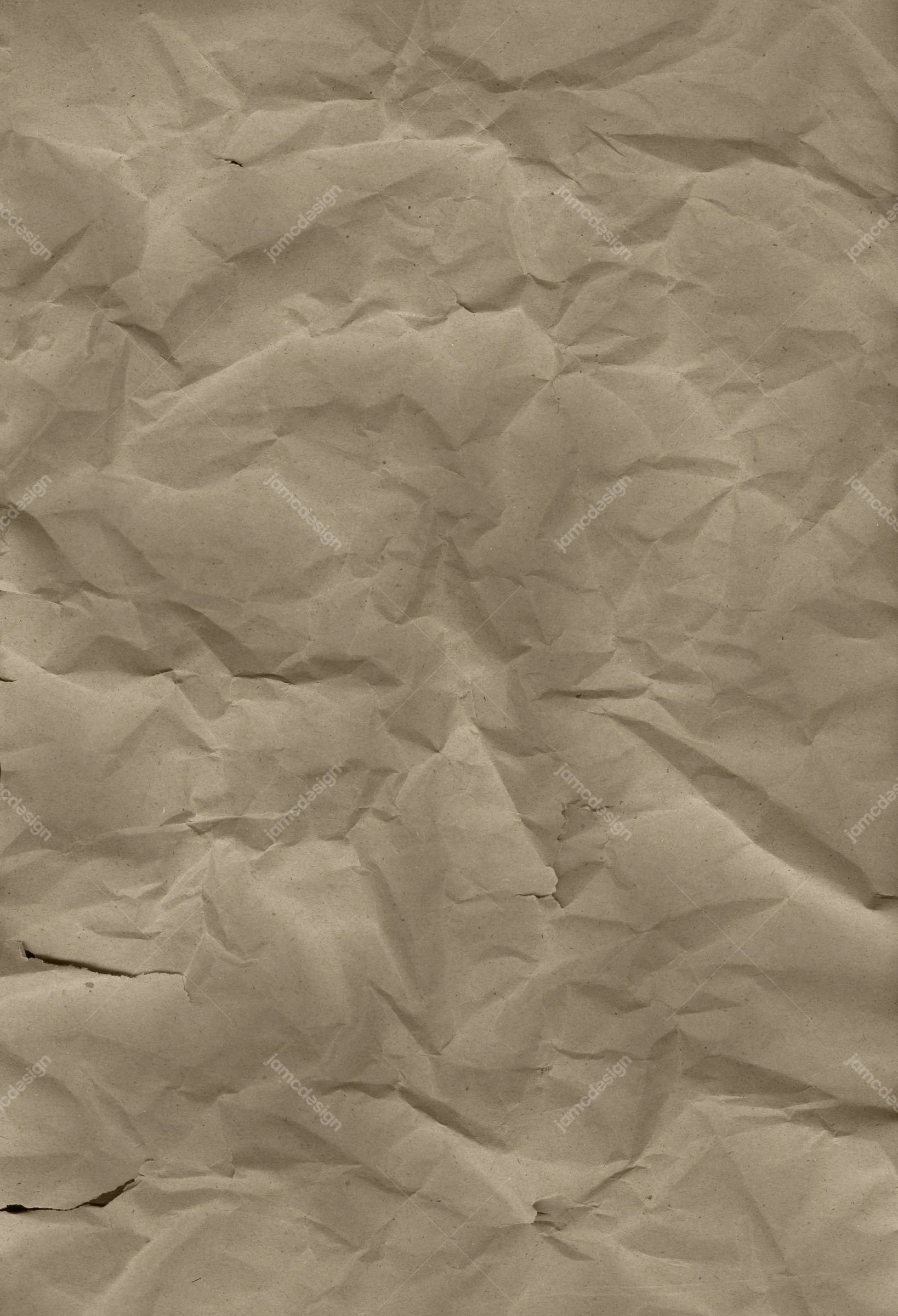 Crumpled Sand-Tone Paper Background. A JPG texture of warm sand toned paper fills the image with dense crumples, creases and uneven shadows
