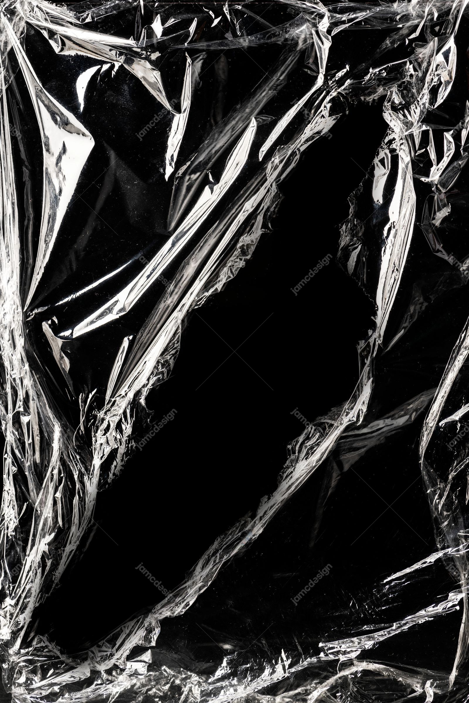 Glossy Crinkled Plastic Texture Against Black. This JPG texture captures crinkled black plastic film with sharp silver highlights and deep dark folds